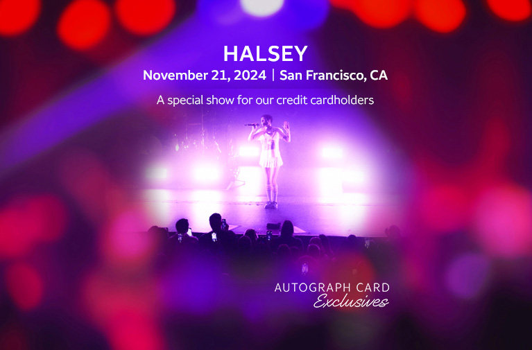 Pop star Halsey, performing on stage with purple lights, wearing a white shirt and white skirt. Halsey. November 21, 2024, San Francisco, CA. A special show for our credit cardholders. Autograph Card Exclusives.